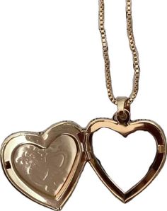 two heart shaped lockes are shown on a gold plated chain with a white background