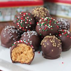 chocolate covered desserts on a white plate with the word interest written in red and green sprinkles