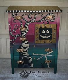 a painted cabinet with an image of a clock and a cat on it's face