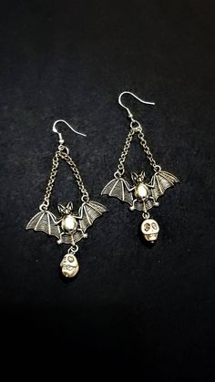 This listing is for 1 pair of new, made to order, Tibetan Silver Bat and Skull  Chandelier Earrings. They are on Hypoallergenic Fish Hook Style posts. Please view all photos for size reference.  Professionally packaged earring post cards, boxed, and branded. Vampire Earrings, Witch Earrings, Gothic Earrings, Halloween Earrings, Jewelry Inspo, Chandelier Earrings, Post Earrings, Jewelry Shop, Beaded Earrings