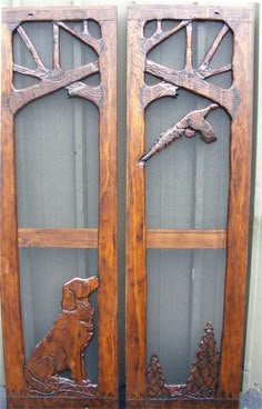 two wooden doors with carved animals and trees on the sides, one has a bird in it's mouth