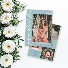 the birth announcement card is next to some flowers and daisies on a white background