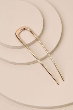 You'll be ready to solve your updo in one simple move when you've got the KITSCH Gold Metal Oversized French Hair Pin! Shiny, gold-toned metal shapes this oversized hair pin that has a chic, simple design with tapered prongs, an engraved logo, and a U-shaped silhouette. Longest Pin Measure 5". 100% Zinc Alloy. Imported. Lulus | Gold Metal Oversized French Hair Pin. French Hair Pins, French Pin, French Twist Pin, French Twist Hair Pin, Large French Hair Pin, Hair Sticks Metal, French Hair, Engraved Logo, Metallic Hair