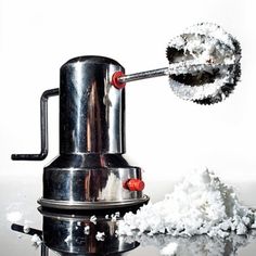 a coffee grinder with powdered sugar around it