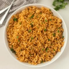 a white bowl filled with rice on top of a table