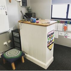 an office with a desk and stools in it