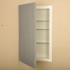 an empty medicine cabinet with glass shelves on the wall