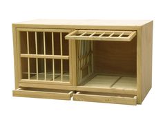 a small wooden cage with bars on the top and doors open to let people inside