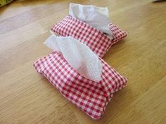 three rolls of toilet paper sitting on top of a wooden floor