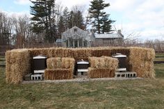 hay bales stacked on top of each other in a field