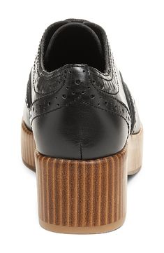 Offering a modern twist on the classic wingtip, this brogued leather oxford is elevated on a vertically stacked platform and heel. 2" heel; 1" platform Leather upper/textile lining/recycled synthetic sole Imported Black Wingtip Platform Loafers, Leather Wingtip Platform Oxfords, Elegant Black Platform Oxfords, Classic Black Platform Oxfords, Black Leather Platform Oxfords, Wingtip Oxford, Womens Oxfords, Oxford, Leather Upper