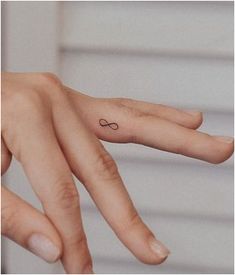 Infinity Eye Catching Finger Tattoo Infinity Symbol Finger Tattoo, Tiny Tattoos Infinity, Finger Love Tattoo, Infinity Tattoo On Ring Finger, Hand Tattoos Infinity, Infinity Minimalist Tattoo, Mini Infinity Tattoo, Infinity Hand Tattoo, Tiny Infinity Tattoos For Women