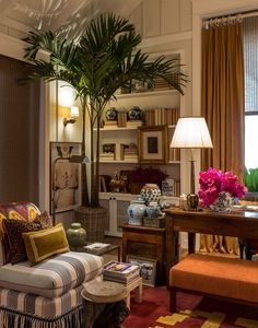 a living room filled with furniture and a potted plant on top of a table