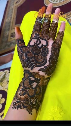 a woman's hand is decorated with hennap and intricate designs on it