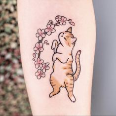 a cat is standing on its hind legs and reaching up for a flower tattoo design