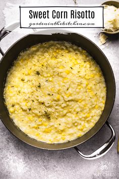 a pan filled with corn risotto on top of a table