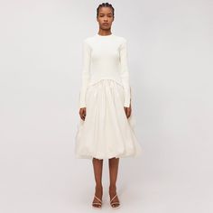 FALL 2024 WOMEN'S COLLECTION The Kenlie Dress in Ivory. Meticulously crafted mock neck midi featuring form-fitting long sleeves with artful side cuts. Sculpted bodice transitions to a voluminous skirt, blending poise with a hint of playful drama. Dress Fit: We recommend sizing down. Fall Evening Long Sleeve White Dress, Fitted White Long Sleeve Dress For Fall, White Fitted Long Sleeve Dress For Fall, White High Neck Midi Dress For Fall, White Midi Dress For Evening In Fall, Fitted Long Sleeve Off-white Midi Dress, Fitted Off White Midi Dress With Long Sleeves, Off White Fitted Long Sleeve Midi Dress, Off White Fitted Midi Dress With Long Sleeves