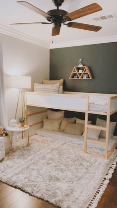 a bedroom with a bunk bed and white rug