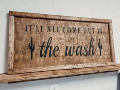 a wooden sign that says, it'll all come out in the washer