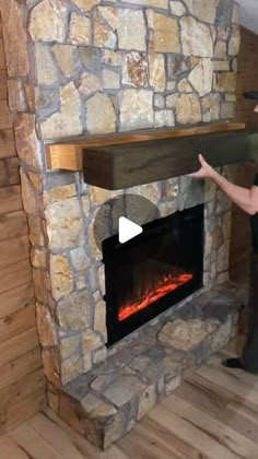 a man standing in front of a stone fireplace