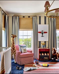 a baby's room with giraffes, zebra print and striped curtains