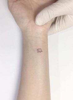 a small elephant tattoo on the wrist