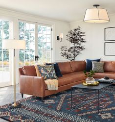 a living room with couches, rugs and pictures on the wall above them