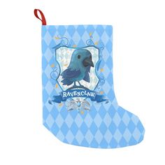 a blue christmas stocking with a black bird on it's head and name ravenclaw