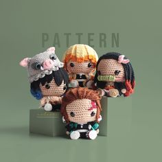 crocheted dolls sitting on top of each other in front of a green background