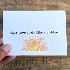 someone holding up a card that says, your love feels like sunshine