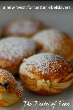 powdered sugar covered pastries sitting on top of a white plate