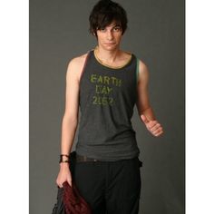 a young man is wearing a tank top with the words earth day written on it