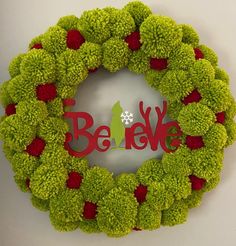 a christmas wreath with the word berk spelled in red and green pom - poms