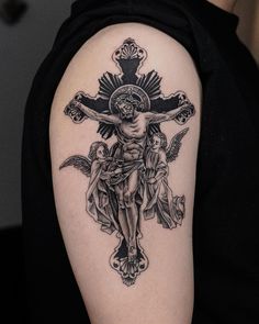 a man with a cross tattoo on his arm