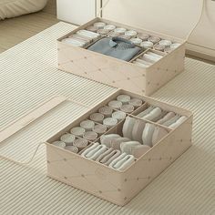 two boxes filled with different types of items on top of a floor next to each other