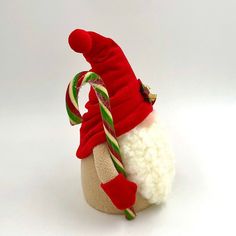 a santa claus hat and candy cane on a white background