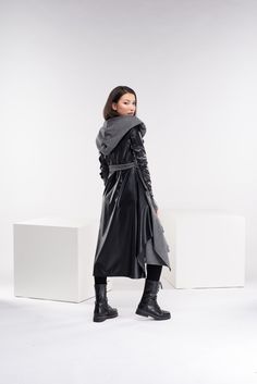 "Stay warm while staying fashionable with our fabulous hooded wool leather cloak. This goth swing coat has two side pockets, a super comfy hood, and thumbholes for a fabulous look. Faux leather elements on the sleeves and the back and long belt as closure. Beautiful cape - it's absolutely out of this world. * The faux leather is always black in color ◼ FIT This asymmetrical cardigan is of cloak is of regular fit. ◾ The model in the picture is wearing size XS in color dark gray ◼ FABRIC ◾ acrylic wool-cotton mix with faux leather ◼ INFO: ◾ Worldwide express shipping - please provide a phone number for shipping documents ◼ CARE ◾ machine wash in cold water or gentle cycle 30oC ⅼ 86℉ ◾ iron at medium temperature ◾ do not bleach ◼ CUSTOMIZATION ◾Don't find the perfect size? Please write us a m Winter Outerwear With Detachable Hood For Alternative Fashion, Black Winter Outerwear For Larp, Avant-garde Outerwear For Cosplay In Fall, Gothic Leather Outerwear For Fall, Avant-garde Outerwear For Fall Cosplay, Avant-garde Cosplay Outerwear For Fall, Cold Weather Long Hooded Jacket With Double-lined Hood, Avant-garde Winter Outerwear With Detachable Hood, Fall Gothic Leather Outerwear