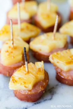 mini pineapples with toothpicks and cheese on them