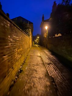 an empty street at night with the lights on