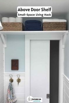 a bathroom with white walls and shelves above the door