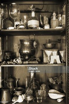 an old fashioned kitchen cupboard filled with pots and pans