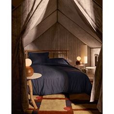 a bedroom with a canopy bed and rugs