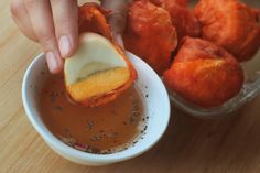 a person dipping something into a small bowl