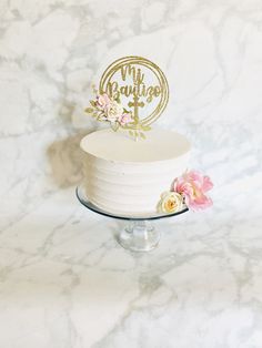 a white cake topped with a gold mr and mrs cake topper on a marble table