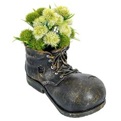 an old boot with some flowers in it