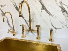 a gold sink and faucet in a bathroom