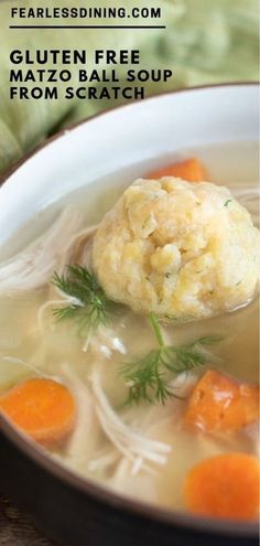 a close up of a bowl of soup with carrots and cauliflower in it