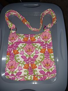 "Beautiful Vera Bradley Crossbody Handbag.  Vibrant colors of pink, orange, yellow,  green on an ivory background.  There are two zipper pockets on the outside with one open pocket.  Inside is one open pocket  Perfect for the summer weather.  This handbag measures 11\"W x  10 \"H x 1.5\"D" Ivory Background, Pink Orange Yellow, Battle Ground, Summer Weather, Sling Bags, Vera Bradley Handbags, Orange Yellow, Pink Orange, Cross Body Handbags