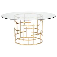 an oval glass table with gold metal accents