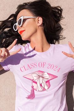 Coquette Class of 2024 Graphic T Shirts.Unisex Crew Neck Short Sleeve Tees.Crafted from premium materials, tailored to your lifestyle, ensuring a comfortable fit for any occasion.Family Group Uniforms Birthday Party Gift Concert Festival Events.High Quality Direct To Film Printed Graphic Design.100%COTTON,HEATHER(52%COTTON,48%POLY),ATH.HEATHER,BLACK HEATHER(90%COTTON,10%POLY)NICARAGUAMade In: Nicaragua Cotton Crew Neck Top For Graduation, Casual Cotton Tops For Graduation, Relaxed Fit Crew Neck Top For Graduation, Custom Print Cotton Tops For Graduation, Cotton Graphic Print Shirt For Graduation, Cotton Letter Print Top For Graduation, Casual Short Sleeve Tops For Graduation, Graphic Tee Tops With Graphic Print For Graduation, Graphic Tee Crew Neck For Graduation